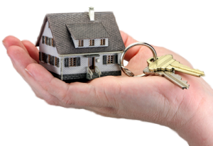 small house keyring with 2 gold keys in palm of hand